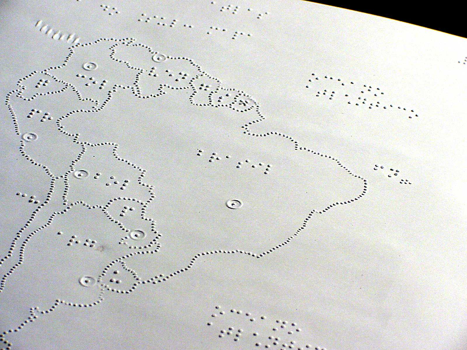 Imagem de uma página braille, com o desenho em relevo do mapa do Brasil.